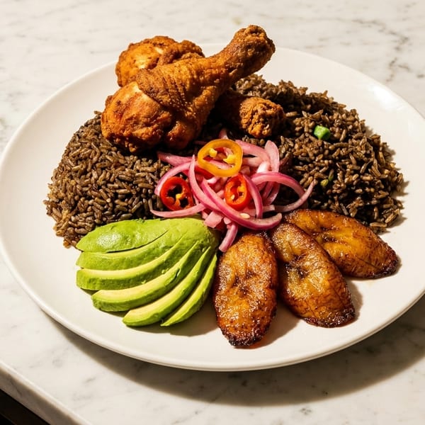 Fried chicken, dark rice, avocado slices, plantains, and pickled onions on a white plate.